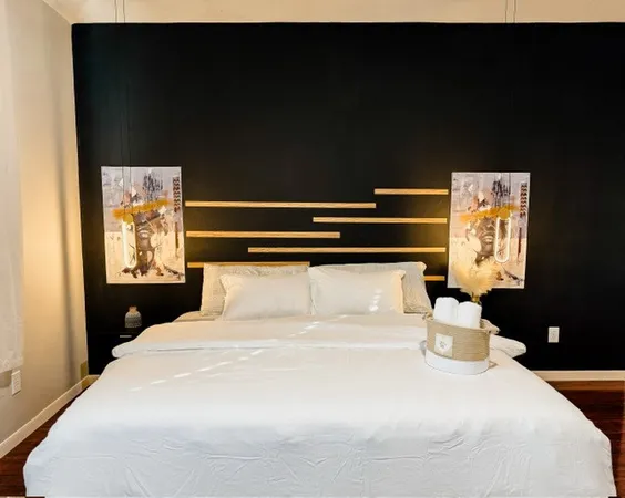 a bedroom with a bed and a flat tv screen on a dresser