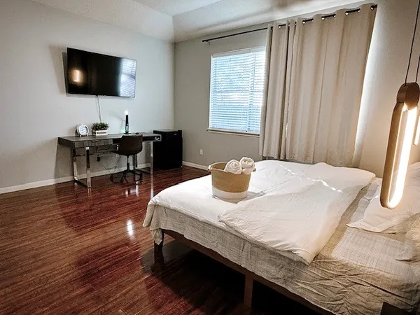 a bedroom with a bed and a window