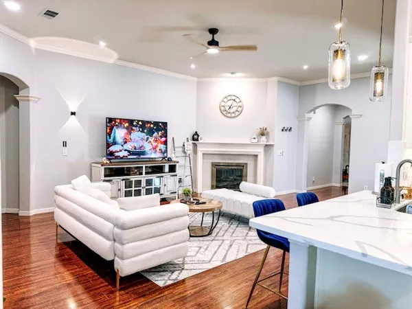 a living room with furniture a fireplace and a flat screen tv