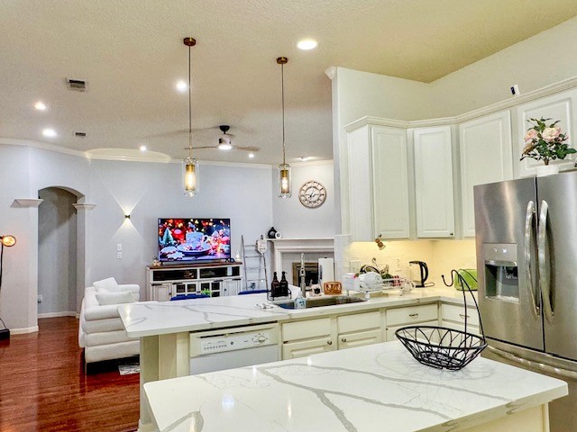 2727 Sunbird Drive Houston, TX 77084 - Photo 5 of 34 a kitchen with a refrigerator a stove and a sink with wooden floor