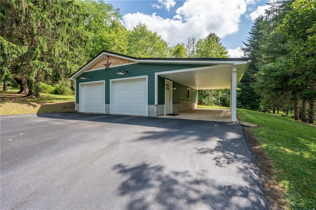 45 Owl Hollow Road Ligonier, PA 15658 - Photo 26 of 30 Oversized 2+ car garage with a covered patio area for seating or storing yard equimpent