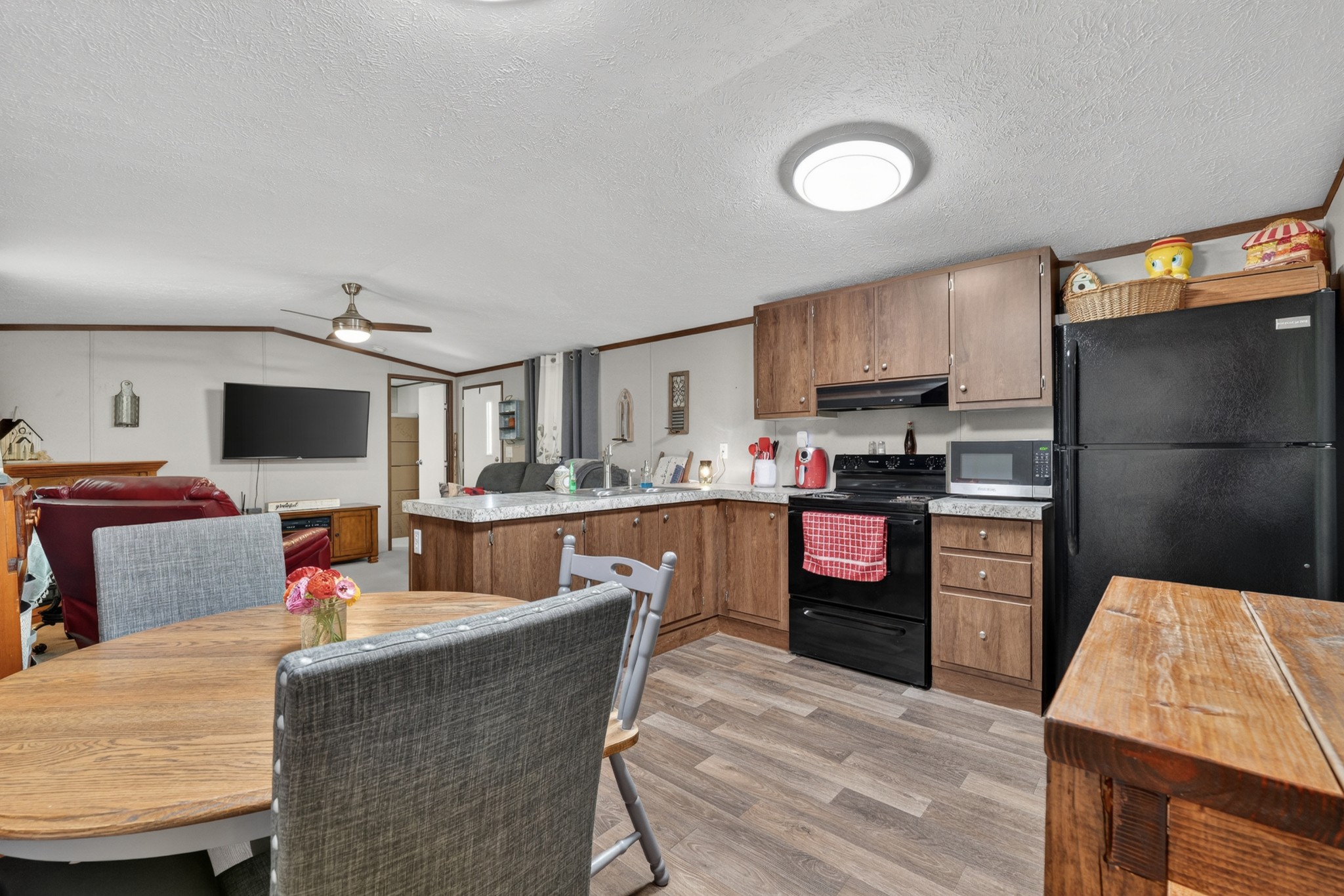 21 Lincoln Lake Road Kelso, TN 37348 - Photo 11 of 26 a kitchen with stainless steel appliances kitchen island granite countertop a refrigerator a stove top oven a sink dishwasher and white cabinets with wooden floor