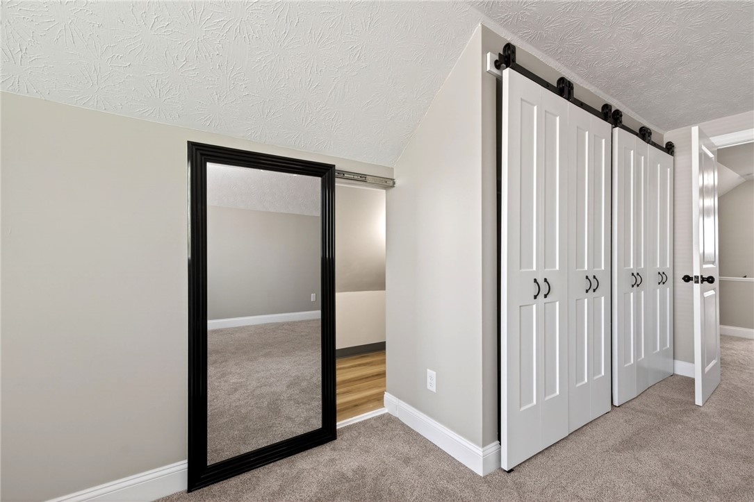 5975 Rosalie Road Dayton, OH 45424 - Photo 30 of 48 This versatile bedroom space offers both plush carpet and modern sliding barn doors.
