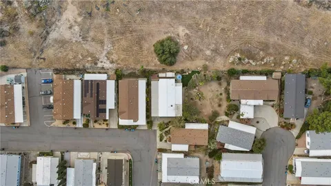 an aerial view of a house with a mountain