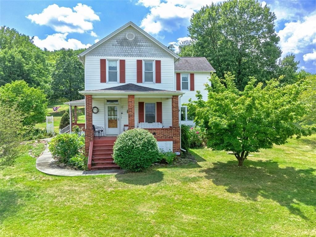 114 Cemetery Road Perryopolis, PA 15473 - Photo 1 of 35 a front view of a house with a yard