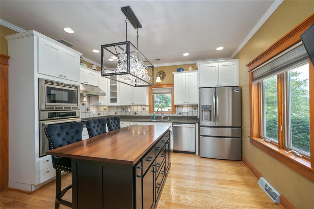 114 Cemetery Road Perryopolis, PA 15473 - Photo 11 of 35 a kitchen with stainless steel appliances granite countertop a sink a stove and refrigerator