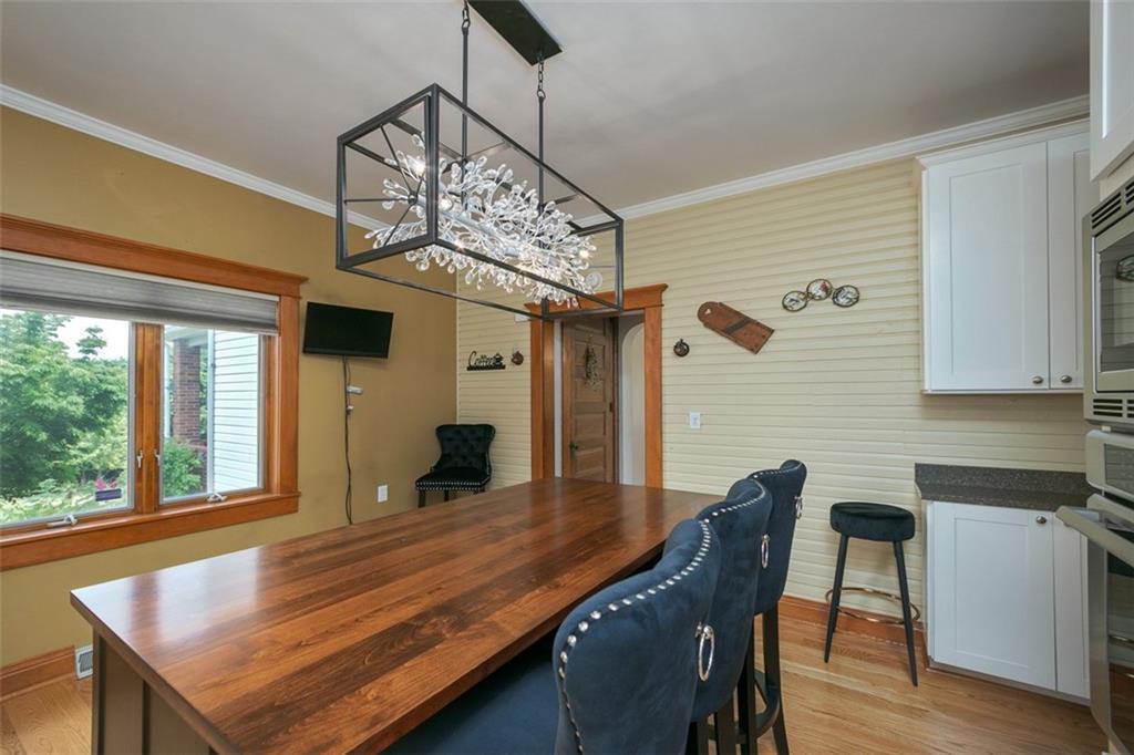 114 Cemetery Road Perryopolis, PA 15473 - Photo 13 of 35 a dining room with wooden floor a chandelier a wooden table and chairs