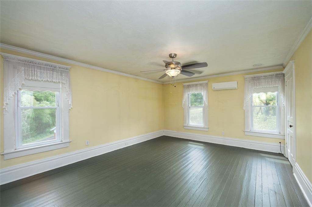114 Cemetery Road Perryopolis, PA 15473 - Photo 17 of 35 a view of an empty room with wooden floor and a window