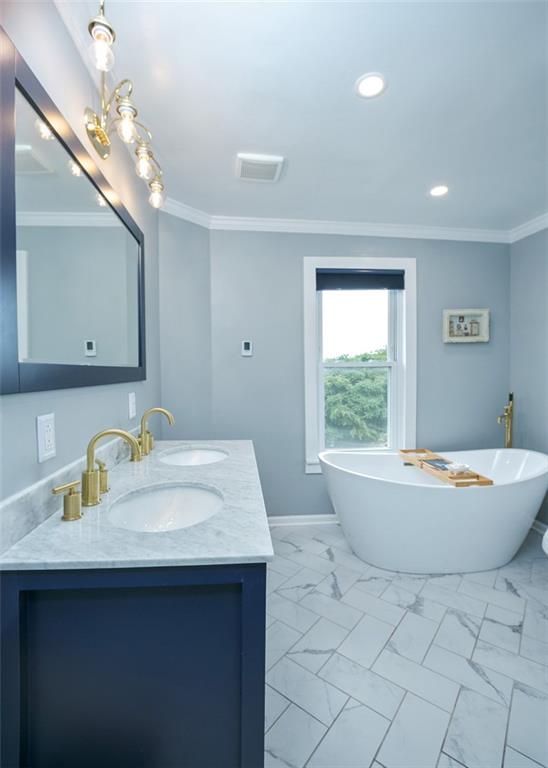 114 Cemetery Road Perryopolis, PA 15473 - Photo 18 of 35 a bathroom with a sink a bathtub and a mirror