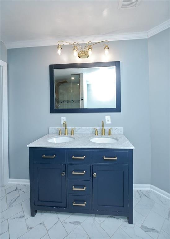 114 Cemetery Road Perryopolis, PA 15473 - Photo 21 of 35 a bathroom with a double vanity sink and a mirror