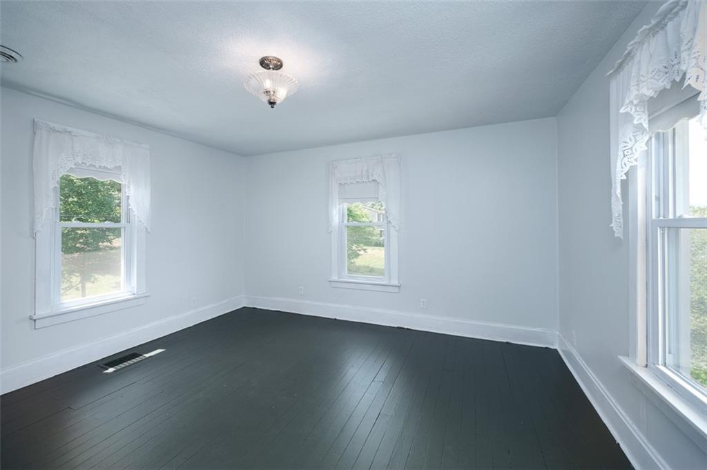 114 Cemetery Road Perryopolis, PA 15473 - Photo 22 of 35 a view of an empty room with wooden floor and a window