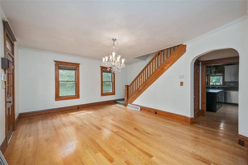 114 Cemetery Road Perryopolis, PA 15473 - Photo 10 of 35 a view of an empty room with wooden floor and a chandelier