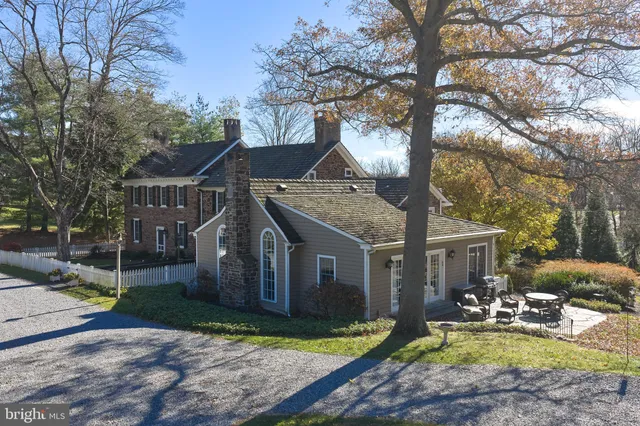 a living room with stainless steel appliances kitchen island granite countertop a stove refrigerator and cabinets