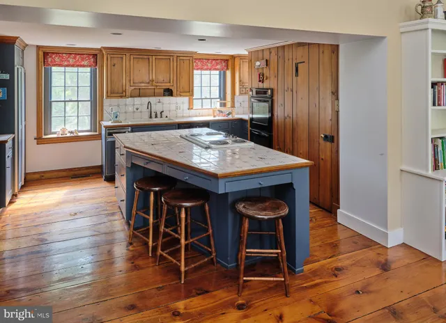a front view of a house with a yard and potted plants