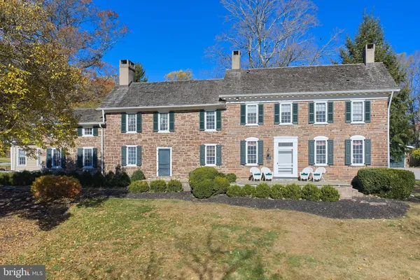 a view of a house with backyard porch and sitting area