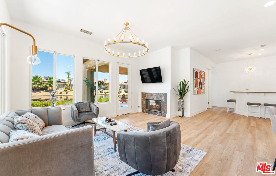 65 Shoreline Drive Rancho Mirage, CA 92270 - Photo 12 of 37 a living room with furniture a fireplace and a flat screen tv