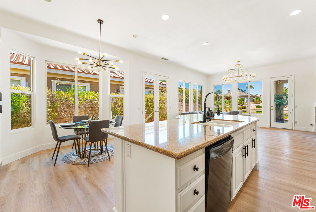 65 Shoreline Drive Rancho Mirage, CA 92270 - Photo 14 of 37 a kitchen with center island table and chairs