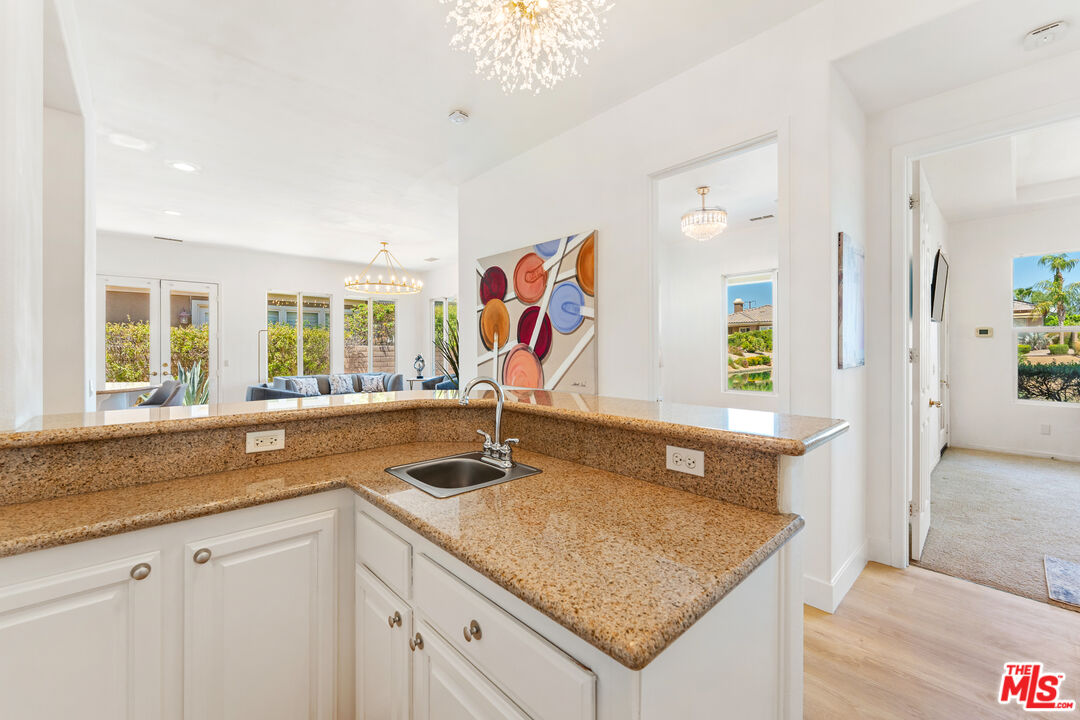 65 Shoreline Drive Rancho Mirage, CA 92270 - Photo 15 of 37 a kitchen with a sink granite counter tops and a window