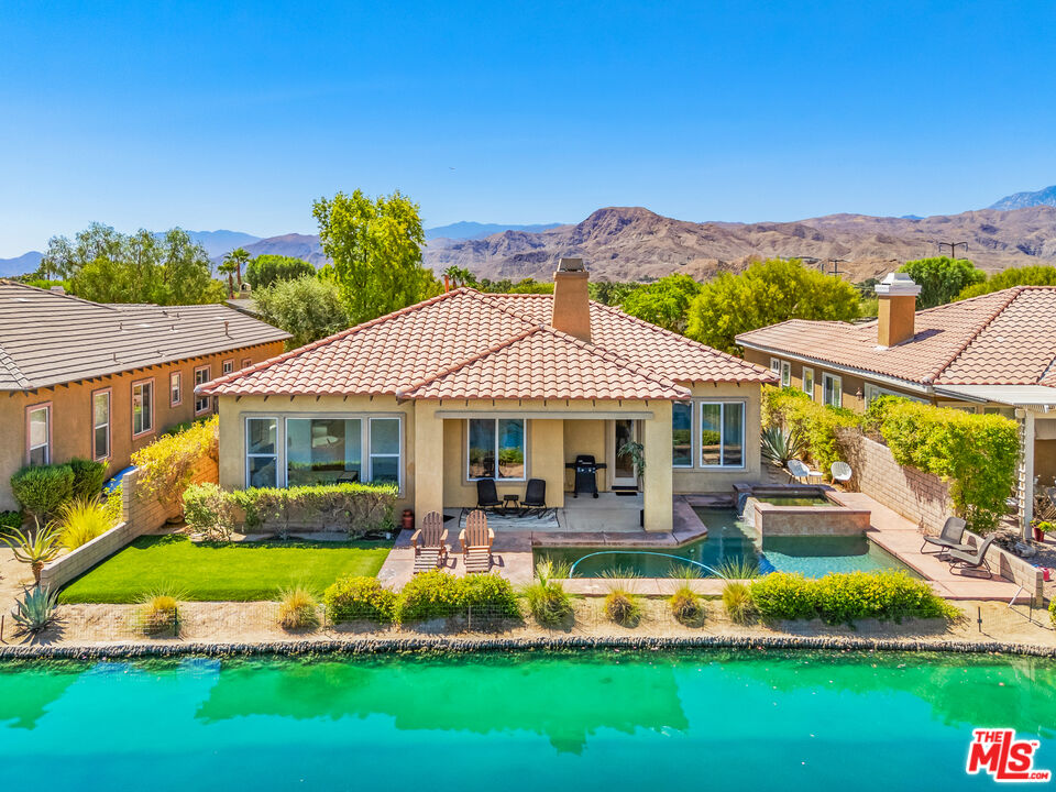 65 Shoreline Drive Rancho Mirage, CA 92270 - Photo 33 of 37 a front view of a house with a yard table and chairs