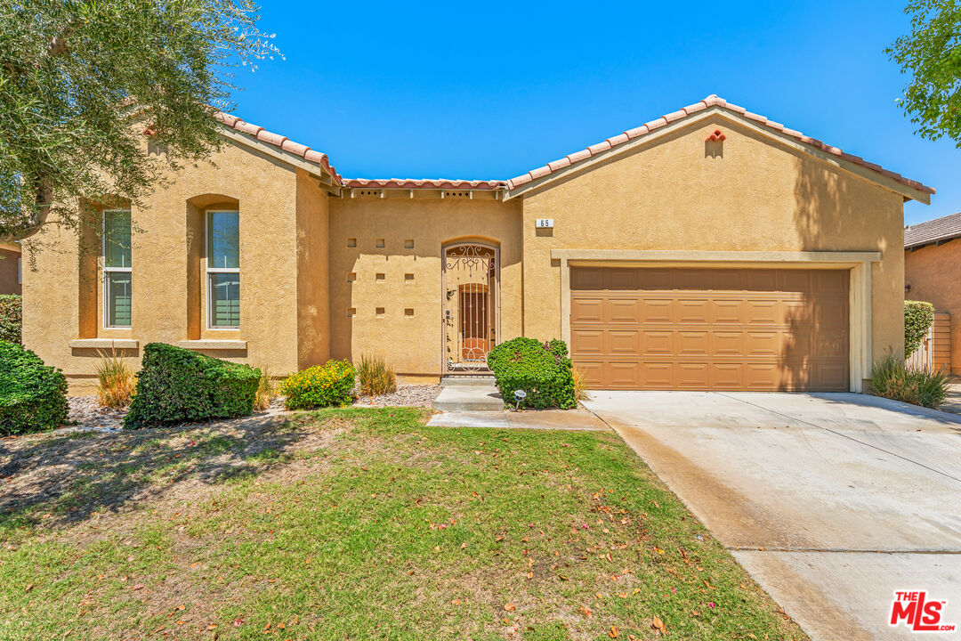 65 Shoreline Drive Rancho Mirage, CA 92270 - Photo 35 of 37 a front view of a house with a yard