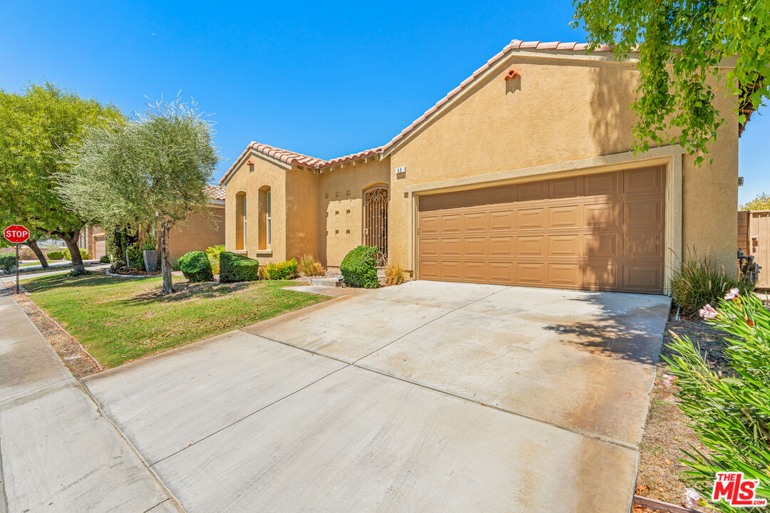 65 Shoreline Drive Rancho Mirage, CA 92270 - Photo 36 of 37 a view of yellow house with a yard and potted plants