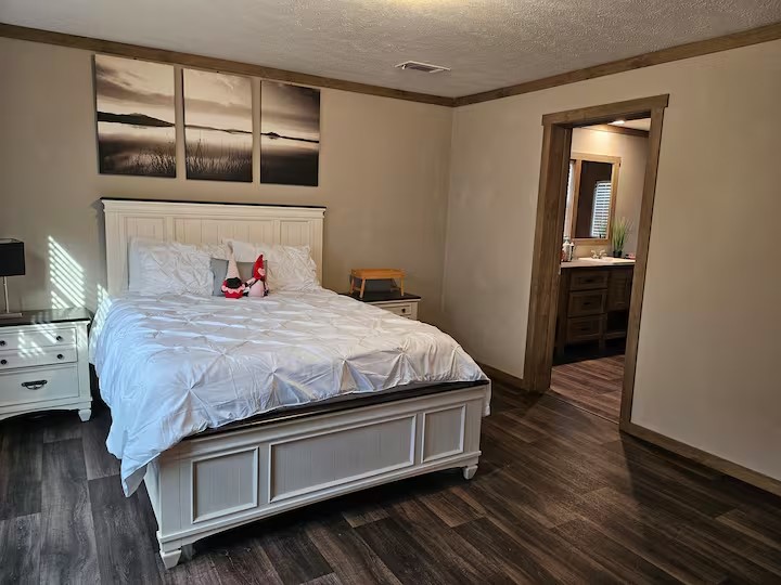 105 Saddle Surrey Road Coldspring, TX 77331 - Photo 27 of 48 a bedroom with a bed and wooden floor