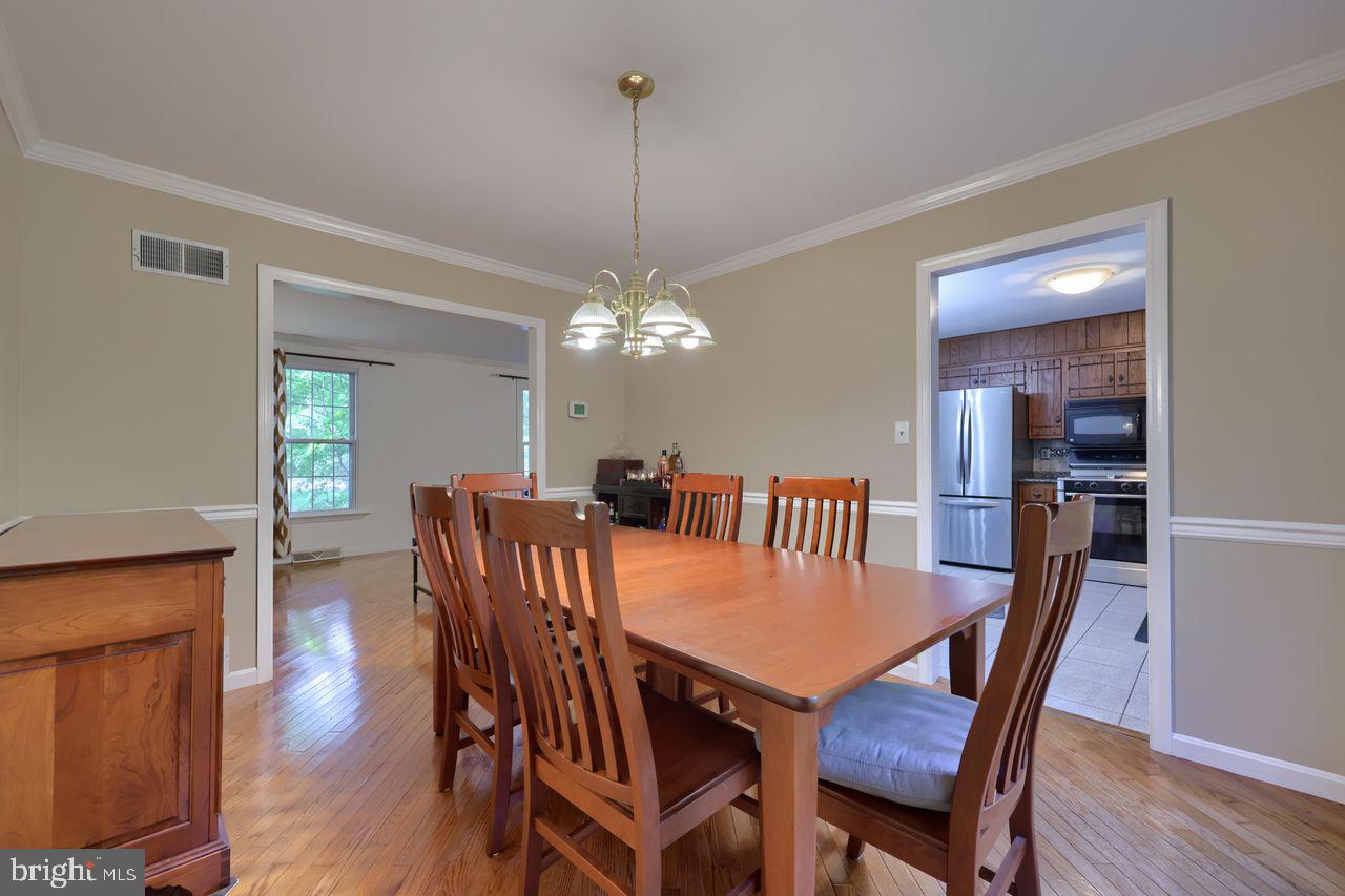 102 Suncrest Road Lancaster, PA 17601 - Photo 20 of 40 a view of a dining room with furniture wooden floor and chandelier