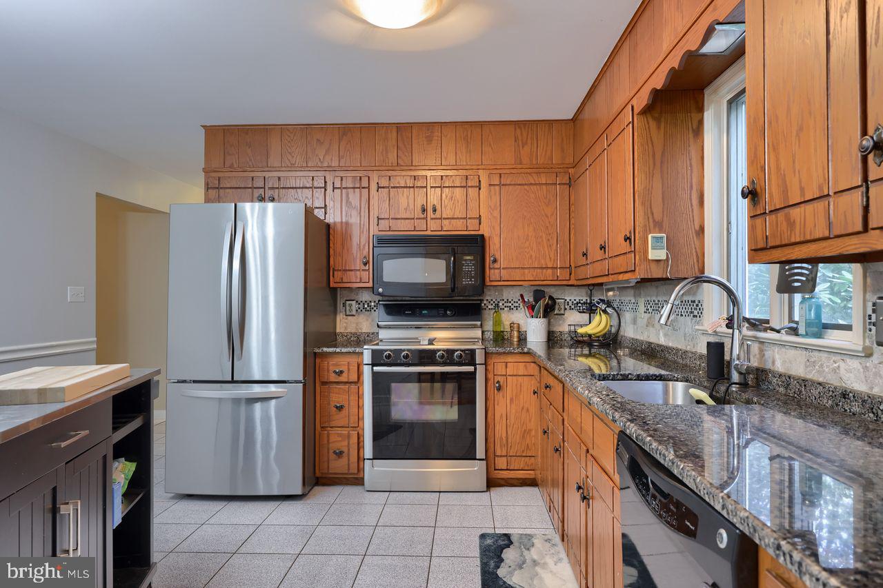 102 Suncrest Road Lancaster, PA 17601 - Photo 23 of 40 a kitchen with stainless steel appliances granite countertop a refrigerator stove and microwave