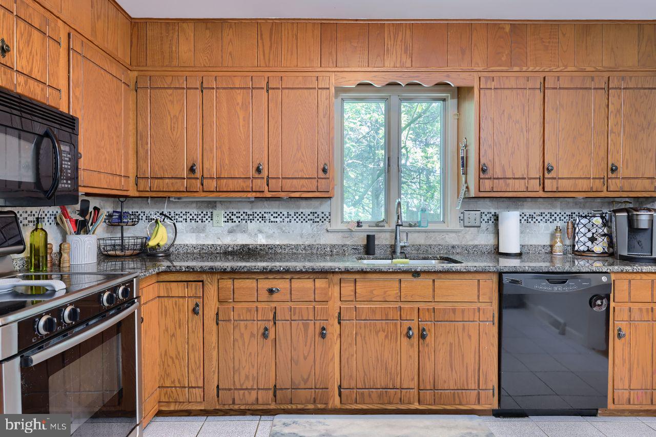 102 Suncrest Road Lancaster, PA 17601 - Photo 24 of 40 a kitchen with granite countertop a sink a window stainless steel appliances and cabinets