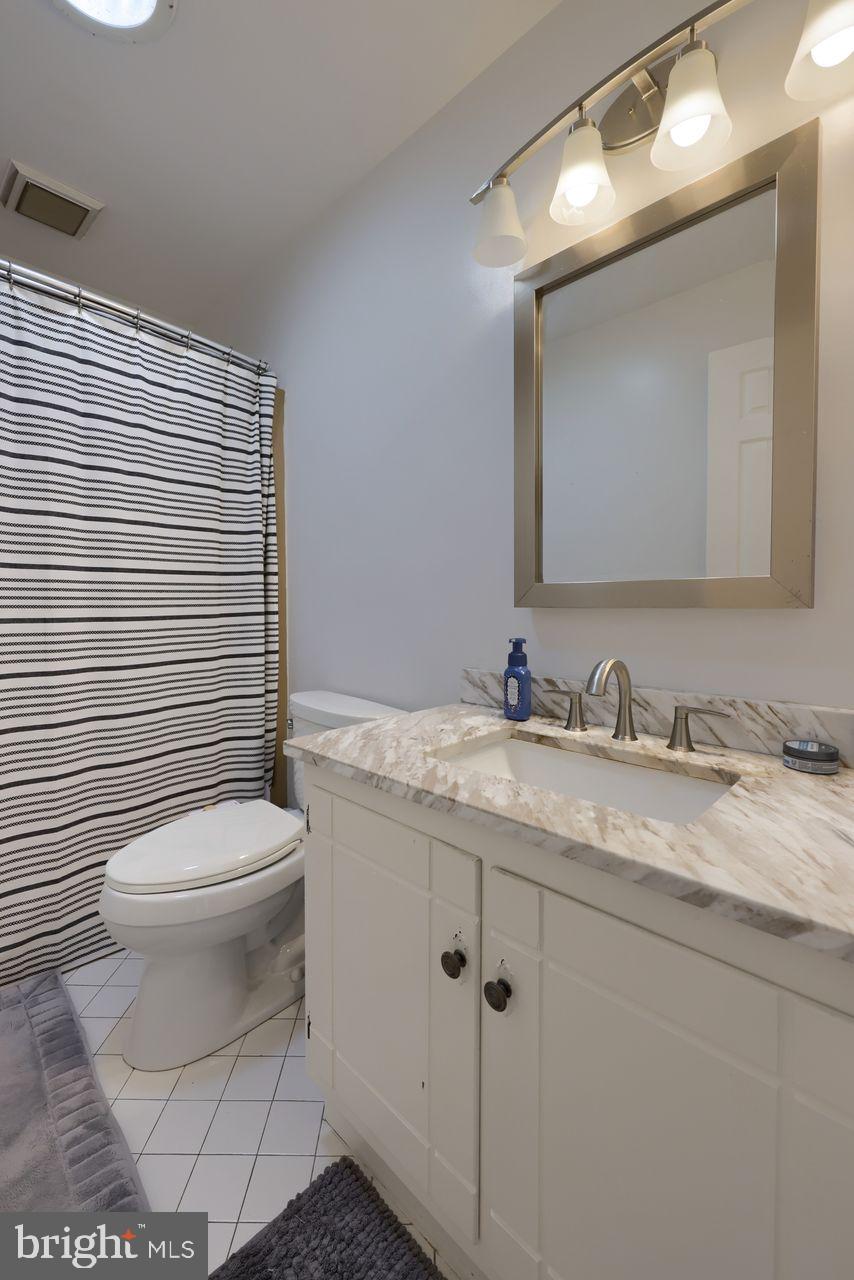 102 Suncrest Road Lancaster, PA 17601 - Photo 35 of 40 a bathroom with a granite countertop toilet sink and mirror