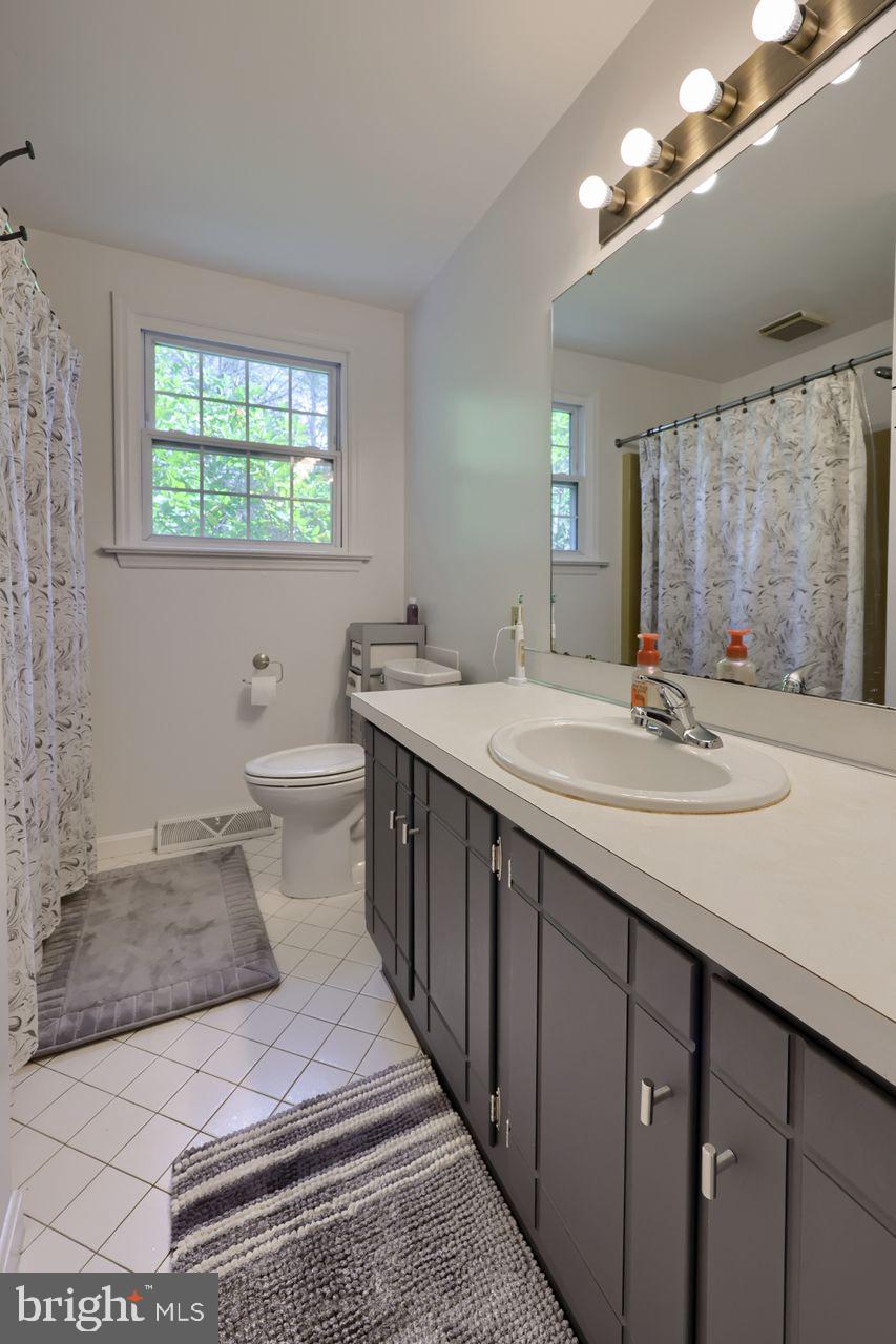 102 Suncrest Road Lancaster, PA 17601 - Photo 38 of 40 a bathroom with a double vanity sink a toilet and a mirror