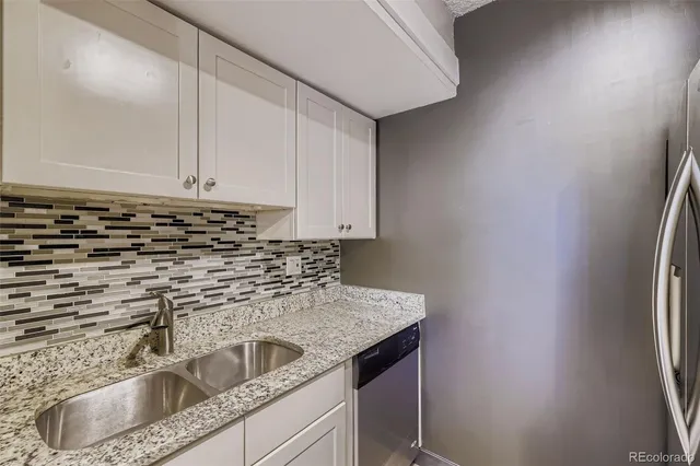 a kitchen with a sink and cabinets