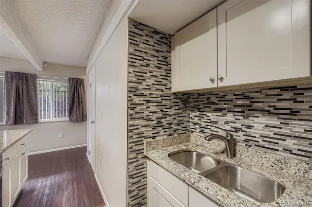 a kitchen with a sink and cabinets