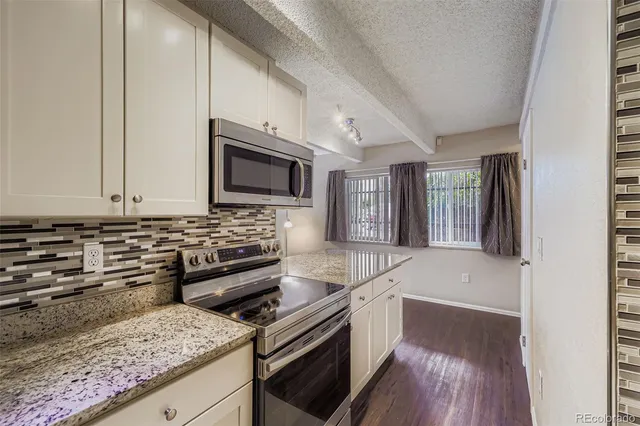 a kitchen with a stove a sink and a microwave