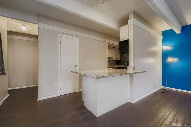 a view of a kitchen with a sink and wooden floor