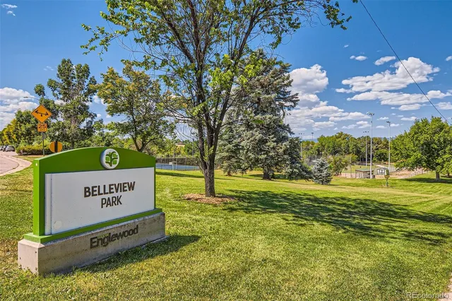 a view of a patio with table and chairs under an umbrella