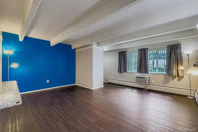 a view of empty room with wooden floor