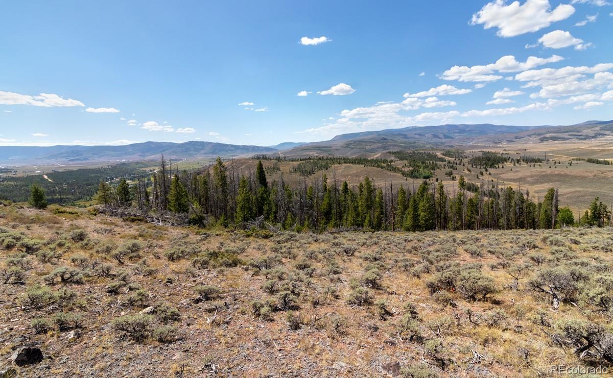 Academy Heights Granby, CO 80446 - Photo 4 of 9 a view of a dry yard with mountains in the background