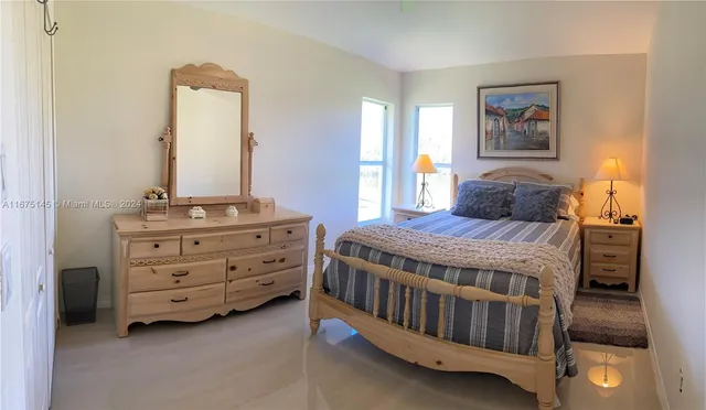 a bedroom with double bed and a window