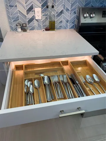a kitchen with sink a refrigerator and furniture