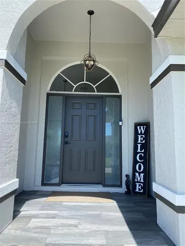 an empty room with wooden floor and cabinet
