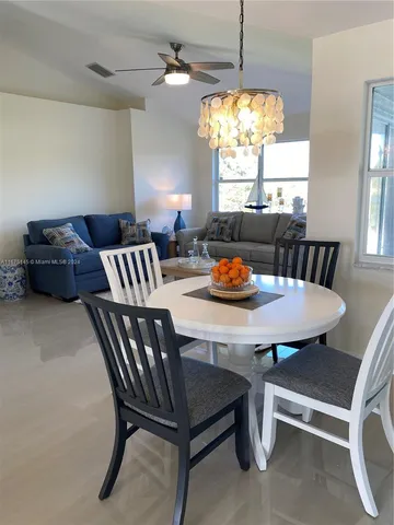 a view of a dining room with furniture window and outside view