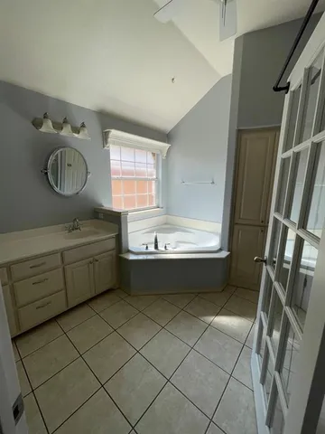 a bathroom with a granite countertop sink a toilet and a mirror