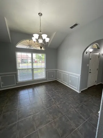 an empty room with fireplace and windows