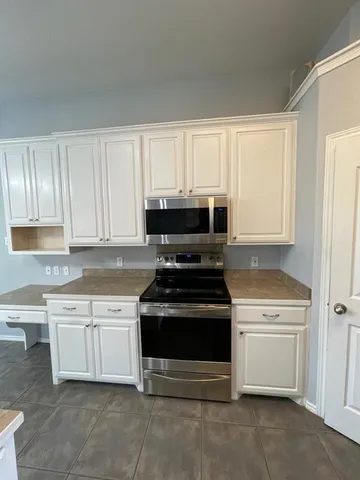 a refrigerator freezer sitting inside of a kitchen