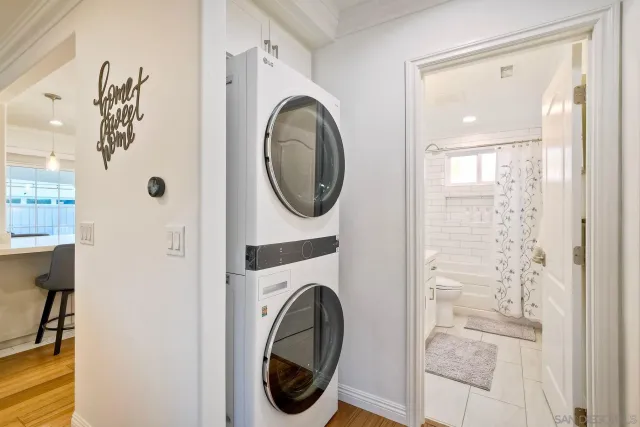 a bedroom with a large bed and a flat tv screen on dresser