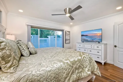 a bedroom with a large bed and a window