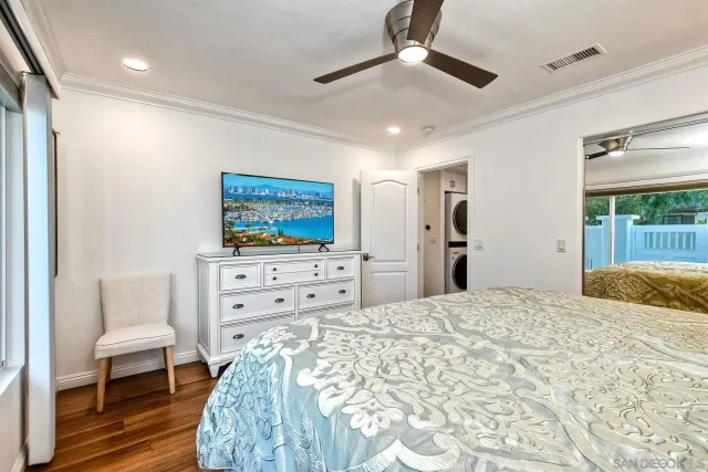 a bedroom with a bed and a painting on the wall