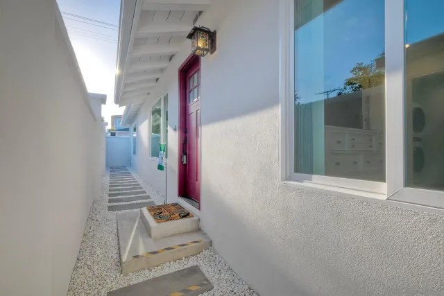 a view of a kitchen with kitchen island stainless steel appliances wooden floor dining table and chairs