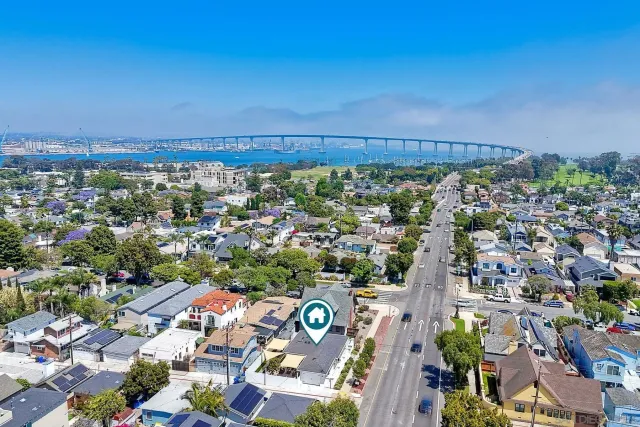 a car parked in front of a white house